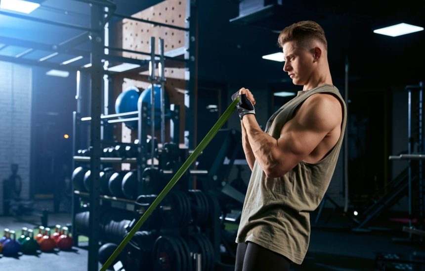 Man strength training at gym